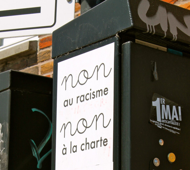 A sign protesting the racism evident in Quebec's recent "Charter of Values," ironically located at the beginning of the fence